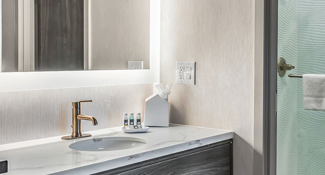 Standard Queen Room bath. Showing large sink, essentials like shampoo and conditione.rThis room comes with a walk in shower.