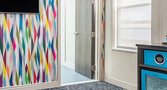 photo showing colorful room with a safe and microwave.