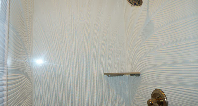 King Guest room has a nice size walk in shower with brass colored fixtures and soap dish.
